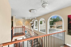 Arched windows, decorative light fixtures, wood-finish flooring, and arched wall niches - 