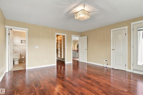 Hardwood flooring, crystal chandelier, built-in shelving, tiled bathroom, and white trim - 14103 60 Avenue Nw, Edmonton, AB 