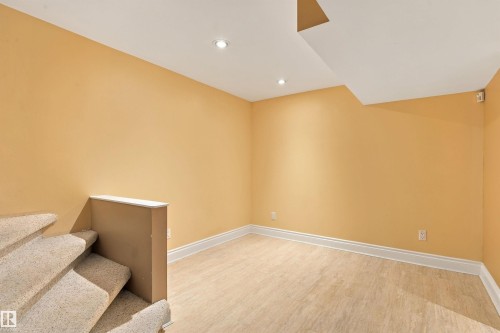 Recessed lighting, light wood-finish flooring, white trim, and a carpeted staircase - 14103 60 Avenue Nw, Edmonton, AB 