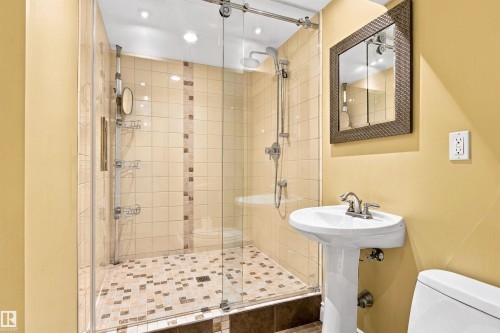Glass-enclosed shower with a tiled surround and mosaic floor - 14103 60 Avenue Nw, Edmonton, AB 