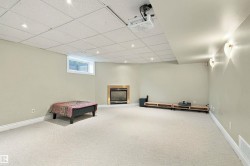Recessed lighting, drop ceiling, wall-mounted sconces, and a built-in fireplace with a metallic trim - 