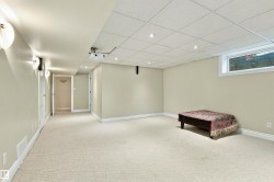 Carpeted flooring, recessed lighting, and wall sconces illuminate this versatile space - 