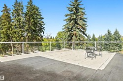 Expansive outdoor patio with glass panel railing - 