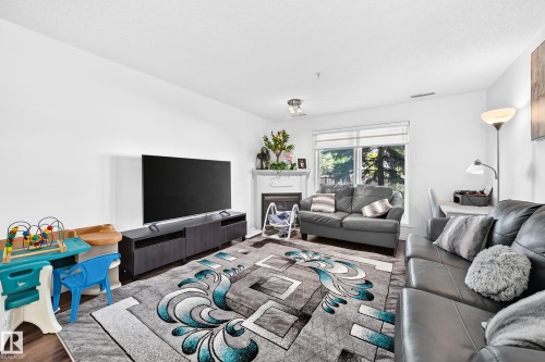 White walls with wood-finish flooring - #133 16311 95 St Nw, Edmonton, AB 
