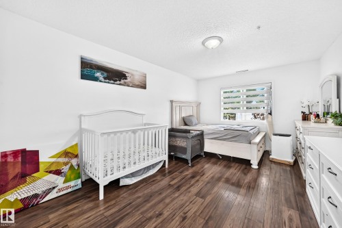 Wood-finish flooring throughout, white painted walls, and a window with blinds - #133 16311 95 St Nw, Edmonton, AB 