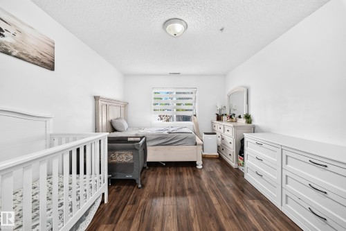 Wood-finish flooring, white walls, and a ceiling-mounted light fixture - #133 16311 95 St Nw, Edmonton, AB 