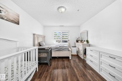 Wood-finish flooring, white walls, and a ceiling-mounted light fixture - 
