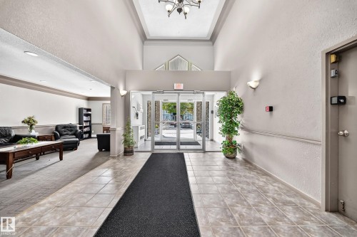Foyer with ceramic tile flooring, tray ceiling, and glass entry doors - #133 16311 95 St Nw, Edmonton, AB 