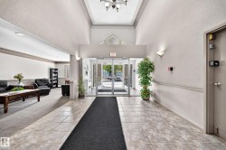 Foyer with ceramic tile flooring, tray ceiling, and glass entry doors - 