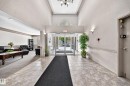 Foyer with ceramic tile flooring, tray ceiling, and glass entry doors - #133 16311 95 St Nw, Edmonton, AB 