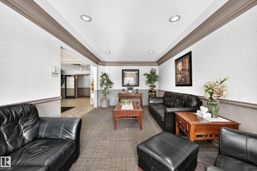 Recessed ceiling lighting illuminates a space featuring a textured wall finish and crown molding - #133 16311 95 St Nw, Edmonton, AB 