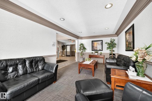 Recessed ceiling lighting illuminates the space, featuring crown molding and wainscoting - #133 16311 95 St Nw, Edmonton, AB 