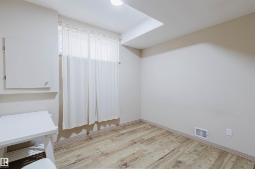 Light wood-finish flooring, neutral wall tones, and recessed ceiling light fixture - 2236 Garnett Court Nw, Edmonton, AB 