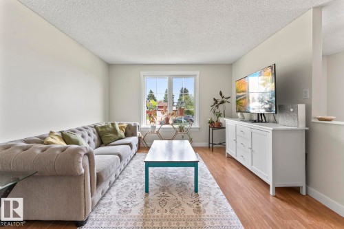 Open-concept living area featuring light-toned walls and wood-finish flooring - 1801 Forest Drive, Cold Lake, AB - Indoor Photo Showing Living Room