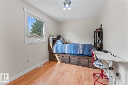 Room with wood-finish flooring, light-toned walls, and a white-framed window - 1801 Forest Drive, Cold Lake, AB - Indoor