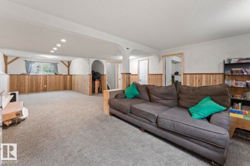 Spacious room featuring light-toned wood wainscoting and neutral carpeting - 1801 Forest Drive, Cold Lake, AB - Indoor Photo Showing Living Room