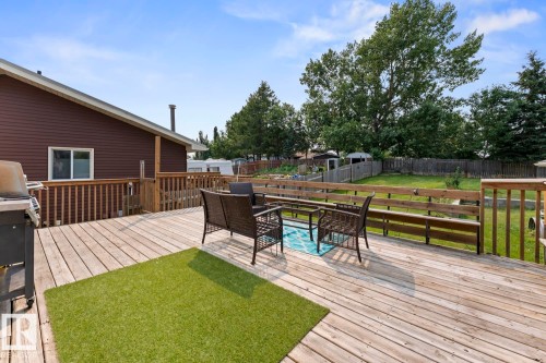 Expansive wooden deck featuring multiple levels and a built-in bench railing - 1801 Forest Drive, Cold Lake, AB - Outdoor With Deck Patio Veranda With Exterior