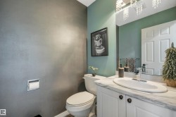 Vanity with white cabinetry, oval sink, and a light-toned countertop - 