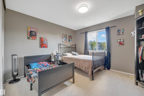 Carpeted flooring, neutral wall tones, and a window with curtains - #13 6608 158 Av Nw, Edmonton, AB 