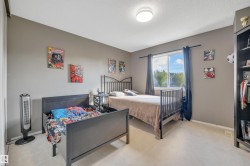 Carpeted flooring, neutral wall tones, and a window with curtains - 
