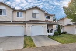 Exterior featuring light-colored siding, multiple gables, and an attached two-car garage - 