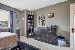 Light gray wall paint, white trim, and a window with dark curtains - 
