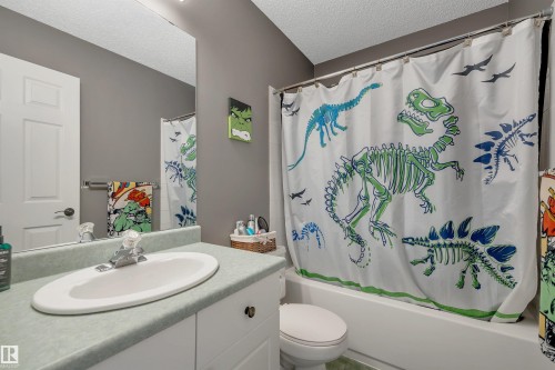 White vanity with an integrated oval sink, paired with a white built-in tub and shower - #13 6608 158 Av Nw, Edmonton, AB 