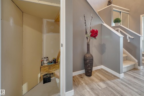Wood-finish flooring with white baseboards - #13 6608 158 Av Nw, Edmonton, AB 