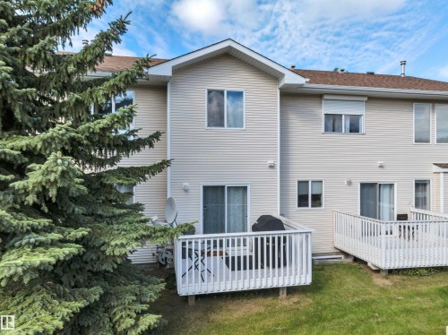Two private decks, each featuring white railings and outdoor access - #13 6608 158 Av Nw, Edmonton, AB 