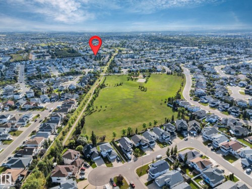 Residential neighborhood featuring a large green space, established tree lines, and paved streets - #13 6608 158 Av Nw, Edmonton, AB 