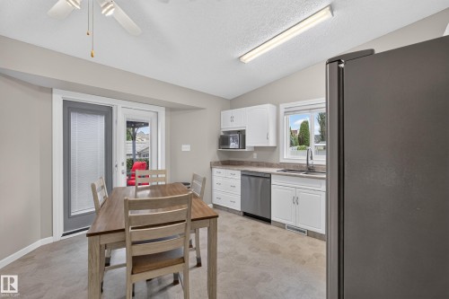 White cabinetry, stainless steel dishwasher, and a window above the sink - 365 Hollick-Kenyon Road Nw, Edmonton, AB 