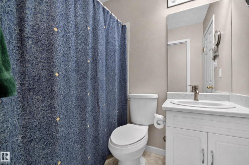 White vanity with panel-front cabinetry, single basin sink, and brushed nickel faucet - 365 Hollick-Kenyon Road Nw, Edmonton, AB 