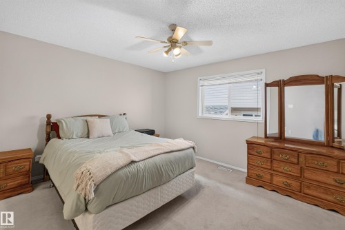 Neutral wall color, ceiling fan with integrated lighting, window with horizontal blinds, and light-toned carpet flooring - 365 Hollick-Kenyon Road Nw, Edmonton, AB 