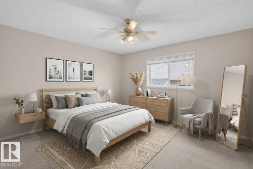 Neutral wall paint, ceiling fan with integrated lighting, window with blinds, wood-finish dresser, and light-toned carpeting - 365 Hollick-Kenyon Road Nw, Edmonton, AB 
