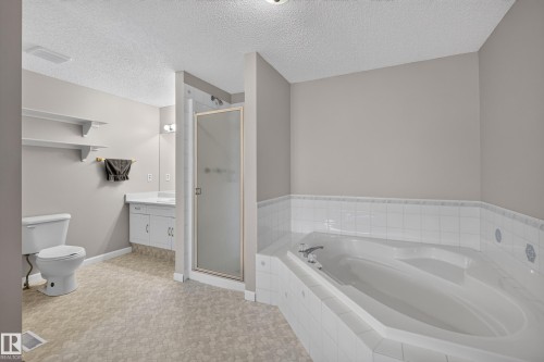 Corner soaking tub with white tile surround - 365 Hollick-Kenyon Road Nw, Edmonton, AB 