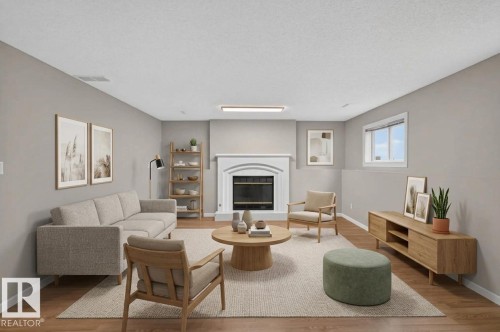 Wood-finish flooring, white trim, a built-in fireplace with a white mantel, and an egress window - 365 Hollick-Kenyon Road Nw, Edmonton, AB 