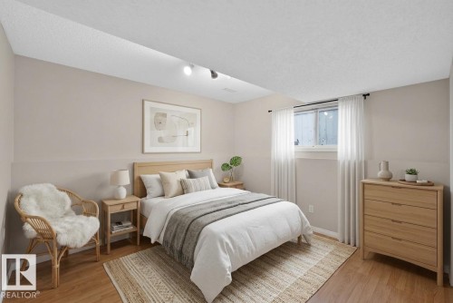 Wood-finish flooring, neutral wall tones, window with natural light, and overhead track lighting - 365 Hollick-Kenyon Road Nw, Edmonton, AB 