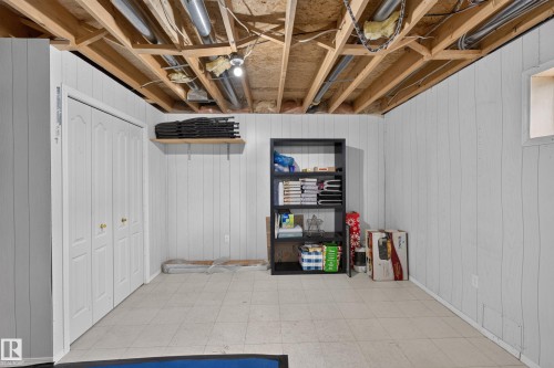 White paneling, bi-fold closet doors, exposed ceiling joists, and a utility window - 365 Hollick-Kenyon Road Nw, Edmonton, AB 