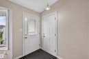 Entryway featuring a white door with decorative glass, a solid white door, and a flush-mount ceiling light - 365 Hollick-Kenyon Road Nw, Edmonton, AB 