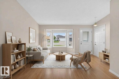 Bay window providing abundant natural light, wood-finish flooring, and a neutral wall palette - 365 Hollick-Kenyon Road Nw, Edmonton, AB 