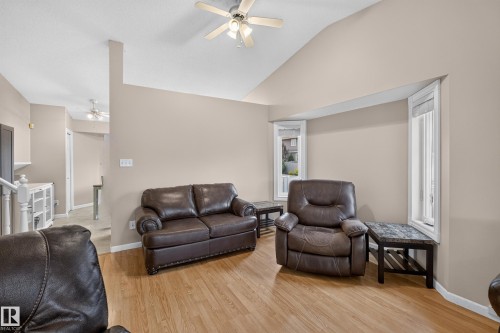 Vaulted ceiling with a ceiling fan, wood-finish flooring, and bay windows - 365 Hollick-Kenyon Road Nw, Edmonton, AB 