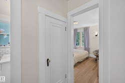 Wood-finish flooring, white walls, white trim, and a built-in wall sconce - 
