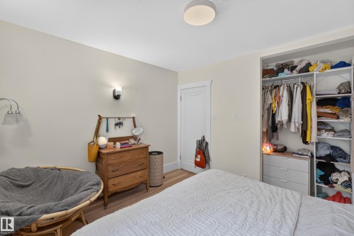 Integrated closet storage with hanging rods and shelving - 11308 123 Street Nw, Edmonton, AB 