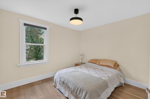 Hardwood-finish flooring, single window, white trim, recessed ceiling light, light-toned walls - 11308 123 Street Nw, Edmonton, AB 