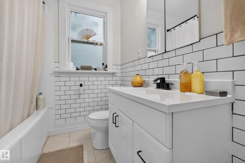 Modern vanity with a white countertop and a matte black faucet - 11308 123 Street Nw, Edmonton, AB 