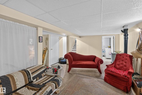 Finished lower-level space with tile flooring, drop ceiling, and light-toned walls - 11308 123 Street Nw, Edmonton, AB 
