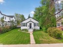 White siding exterior with a dark-pitched roof, front entry with steps, and a paved walkway - 11308 123 Street Nw, Edmonton, AB 