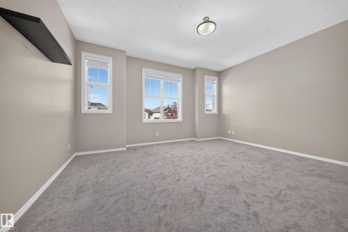 Neutral-toned wall paint with light gray carpeting - 121 64 Street Sw, Edmonton, AB 