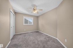 Vaulted ceiling with a ceiling fan, neutral wall paint, white trim, gray carpet, and a window with blinds - 