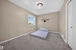 Neutral-toned walls, gray carpet flooring, white trim, and a built-in closet with bifold doors - 